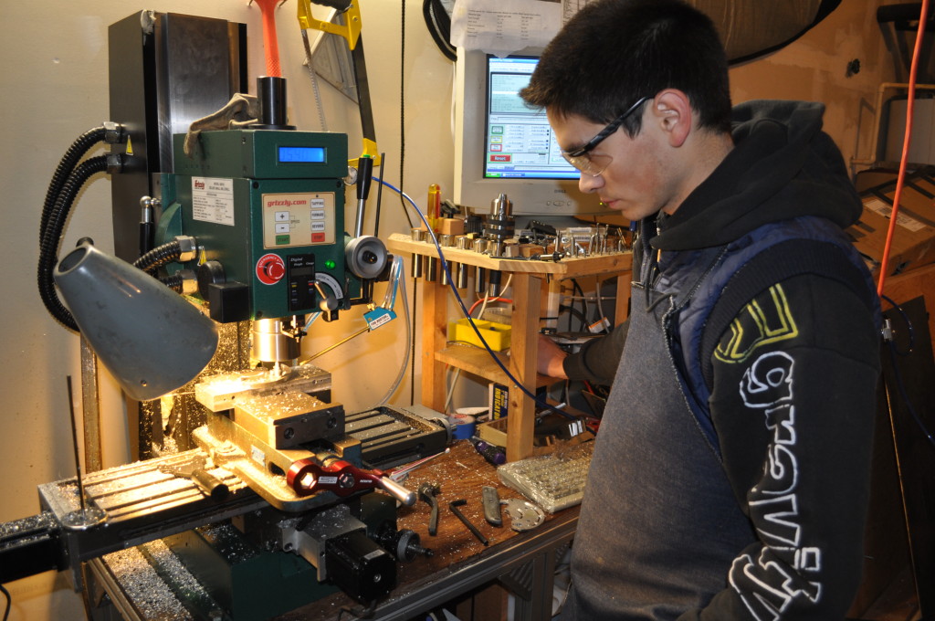 Tyler milling out a prototype component in the garage